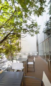 a balcony with tables and chairs on a building at Amérian Rosario in Rosario