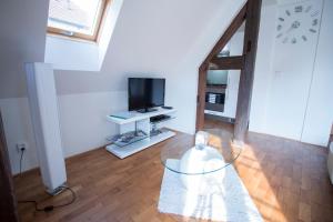 a living room with a glass table and a tv at Apartments Old Town Square 27 in Prague
