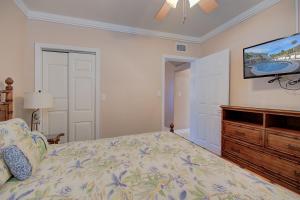 a bedroom with a bed and a flat screen tv at Clearwater Beach Suites 102 condo in Clearwater Beach