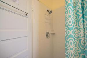 une douche avec rideau de douche bleu et blanc dans l'établissement Sandy Shores - Weekly Rental home, à Clearwater Beach