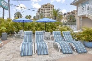 a group of chairs and umbrellas on a patio at Clearwater Beach Suites 201 condo in Clearwater Beach