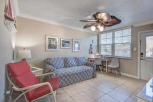 a living room with a couch and a ceiling fan at Clearwater Beach Suites 201 condo in Clearwater Beach