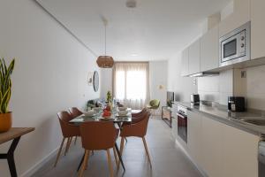 a kitchen and dining room with a table and chairs at Royal Flats in Las Palmas de Gran Canaria