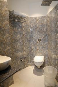 HOTEL AVI INN BY JR GROUP OF Hotels 50 Meter from Golden Temple في أمريتسار: حمام مع مرحاض ومغسلة