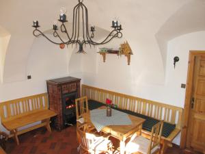a dining room with a table and a chandelier at Kovárna in Nová Paka