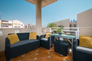eine Terrasse mit Sofas und einem Tisch auf dem Balkon in der Unterkunft 211 Cabo Roig Dream - Alicante Holiday in Cabo Roig