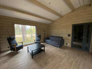 a living room with a couch and chairs and a table at Villas Karhunpesä in Saariselka