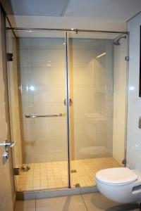 a glass shower in a bathroom with a toilet at Zimbali Suites 324, Capital Hotel Complex in Ballito +3 photos