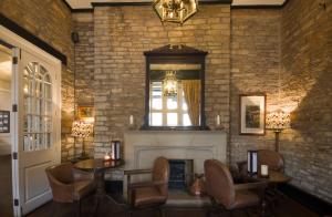 a living room with a fireplace and a window at The Snooty Fox in Tetbury