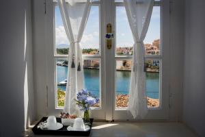 a room with a large window with a view of the water at Galaxa Mansion in Galaxidhion