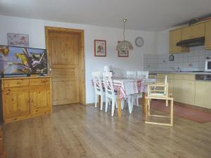 a kitchen with a table and chairs in a room at Haus Meinecke in Bad Hindelang +20 photos