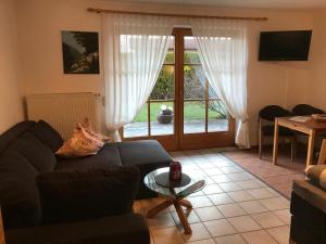 a living room with a couch and a table at Appartement Hildegard in Rieden
