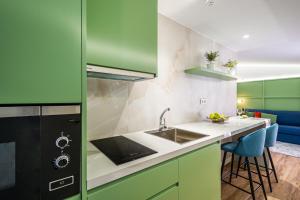 
a kitchen with a sink, stove, microwave and refrigerator at Intur Castellon in Castellón de la Plana
