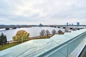 a bridge over a river with a view of a city at Wellton Riverside SPA Hotel in Riga