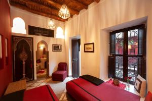ein Schlafzimmer mit einem roten Bett und einem Fenster in der Unterkunft Riad Boussa in Marrakesch