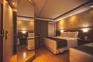 Postel nebo postele na pokoji v ubytování Hotel Rafain Centro