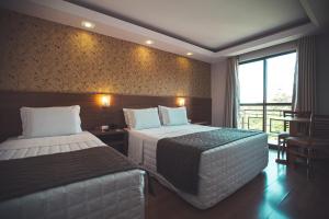 Postel nebo postele na pokoji v ubytování Hotel Rafain Centro