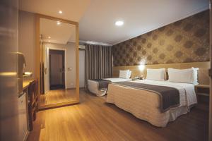 Postel nebo postele na pokoji v ubytování Hotel Rafain Centro