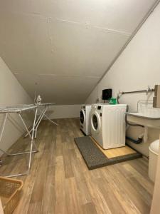 a laundry room with a washer and dryer in a attic at Meerestraum in Grömitz