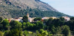 a small town in front of a mountain at Casa Les Olives - Adults Only in Benichembla