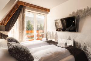 Posteľ alebo postele v izbe v ubytovaní Apartament Giewont House & Spa z Sauną Zakopane