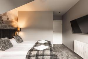 Posteľ alebo postele v izbe v ubytovaní Apartament Giewont House & Spa z Sauną Zakopane