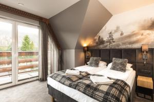 Posteľ alebo postele v izbe v ubytovaní Apartament Giewont House & Spa z Sauną Zakopane
