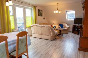 a living room with a couch and a table at Ferienwohnung Sukow in Freest