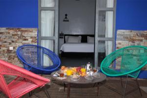 a room with a table and two chairs and a bed at Joumaya Blue Manoir in Casablanca