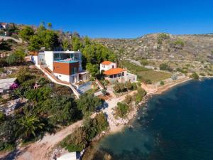 an aerial view of a house on a hill by the water at Luxury Beachfront Villa Blue Star of Brac with private pool at the beach on Brac island - Bobovisca in Bobovišća