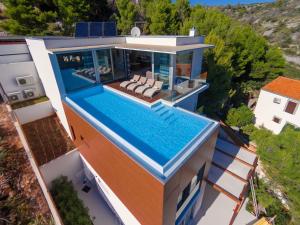 an aerial view of a house with a swimming pool at Luxury Beachfront Villa Blue Star of Brac with private pool at the beach on Brac island - Bobovisca in Bobovišća