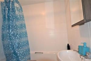 a bathroom with a shower and a sink at London Zone 2 Lovely 4 bedroom Apartment - 3 Trowbridge Road in London