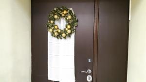 a door with a christmas wreath on it at Friedental Hotel in Pushkin