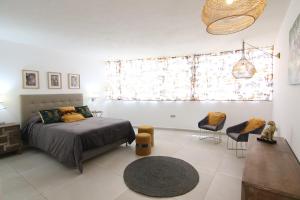 a bedroom with a bed and a table and chairs at Villa Ozeano in Costa Calma +41 photos