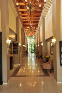 a hallway in a building with a ceiling with lights at Safari Hotel & Convention Centre in Rustenburg