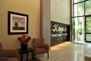 a lobby with chairs and a sign that reads steveston comeeat cafe at Safari Hotel & Convention Centre, Rustenburg in Rustenburg
