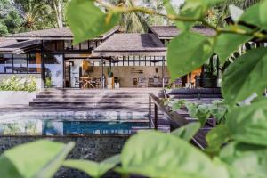 a resort with a swimming pool and a house at Villa Kanan, Secluded Jungle Paradise in Selong Belanak