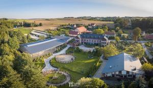 an aerial view of a resort with a large building at Akademia Kuraszków in Kuraszków