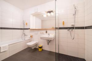a bathroom with a toilet and a sink and a shower at Design Apartments - "Am Weinberg" in Potsdam