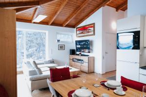 a living room with a table and a couch at Golf Bad Kleinkirchheim in Bad Kleinkirchheim