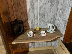 a wooden shelf with two cups and a kettle on it at L'Induss in Herstal