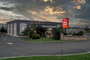 a coca cola building with a sign in front of it at Red Roof PLUS Newark Liberty Airport - Carteret in Carteret