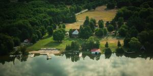 an island in the middle of a lake with a house at Fountain Point in Suttons Bay