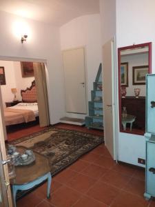 a bedroom with a bed and a room with a table at da lina in Porto Santo Stefano