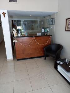 a bar in a hallway with a black chair at Hotel Hawaii in Mar del Plata