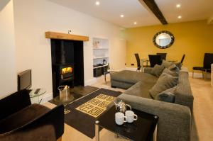 a living room with a couch and a fireplace at Anns Cottage, Chapel Stile in Chapel Stile
