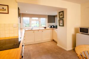 a small kitchen with a sink and a microwave at Langdale Hideaway in Chapel Stile