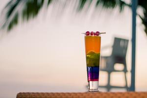 a colorful drink sitting on top of a table at La Playa Estrella Beach Resort in Bantayan Island