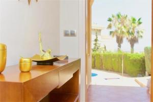 a kitchen with a counter and a view of a patio at 3 Bed House - Sleeps 6 - Pool - Garden - Parking in Atamaría
