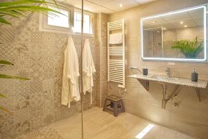 a bathroom with a shower with a sink and a mirror at 3 Bed House - Sleeps 6 - Pool - Garden - Parking in Atamaría +26 photos